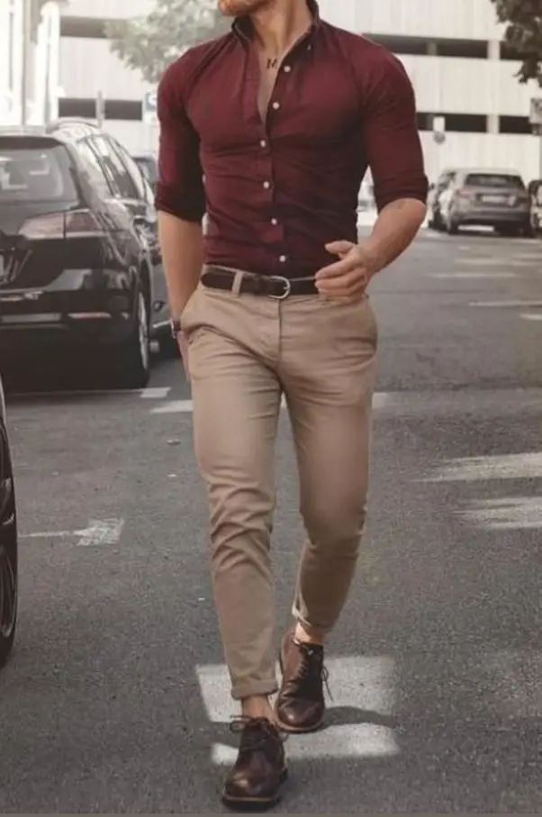 A maroon shirt and light brown jeans